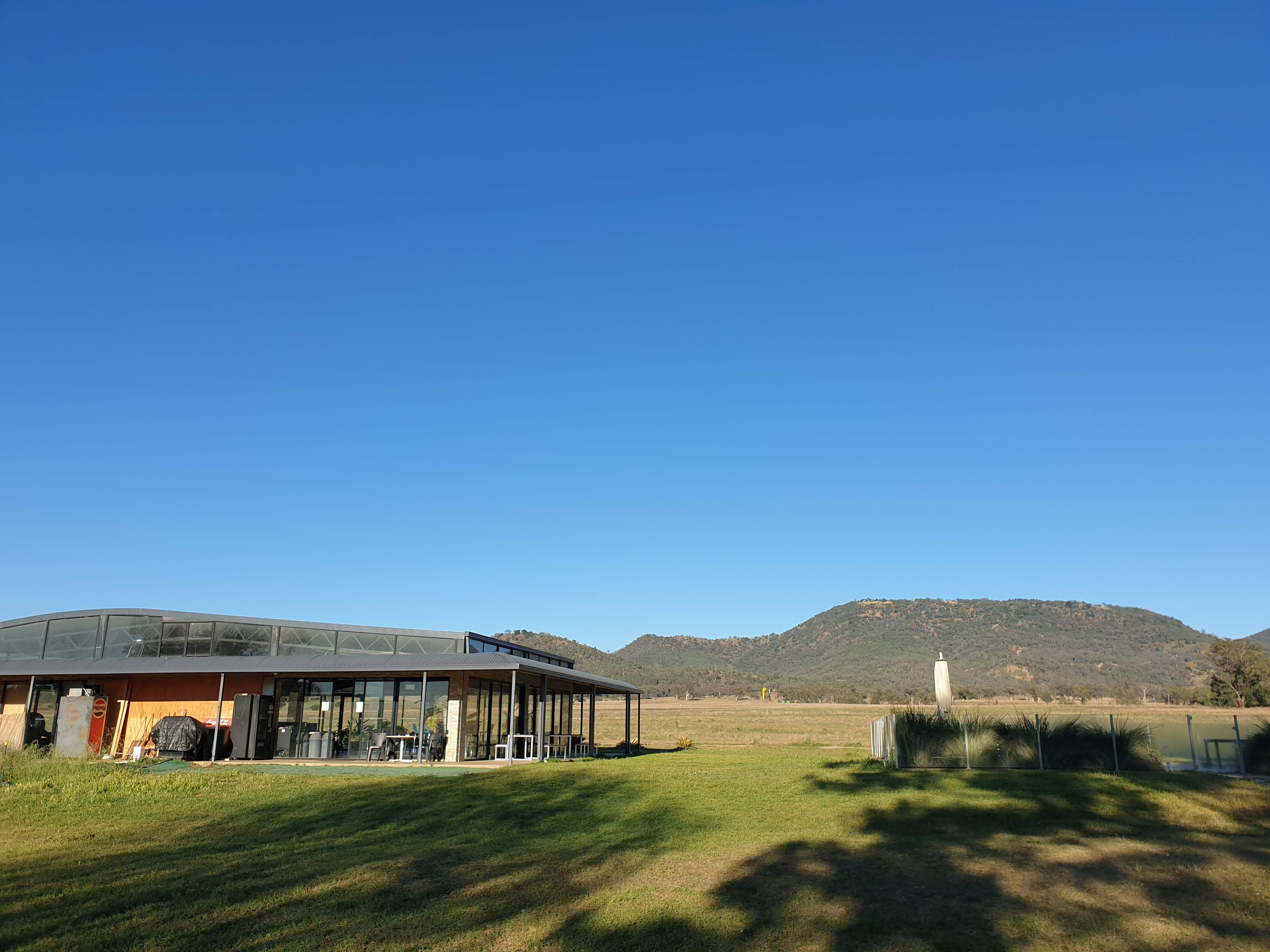 The headquarters building with the paddock and Mt Borah in the background